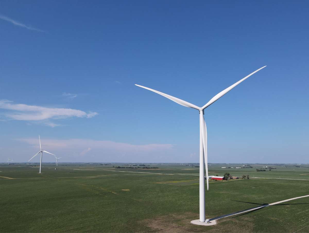 An open field with a large windmill on the right hand side